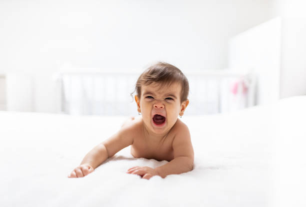 istock Yawning baby in diapers 1209638279