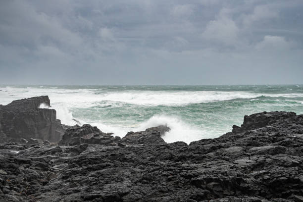 Brimketill lava rock pool Iceland waves hitting black basalt rock