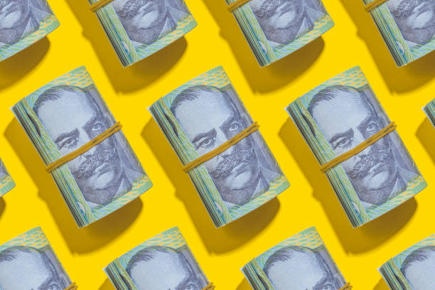 istock Australian dollar rolls flat lay on yellow background 1209639599