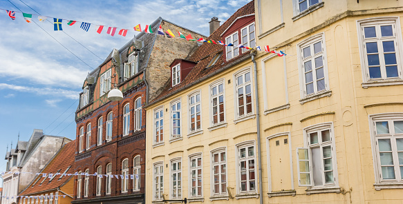 Panorama of old buildings and flags in the historic center of Haderslev, Denmark