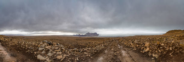 Langjokull Glacier behind huge muddy and rocky wasteland in the heart of iceland stock photo