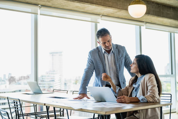 istock Business partners in their 40s collaborating on document 1209643289