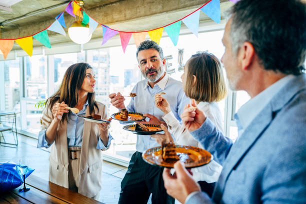 istock Colleagues taking a break to celebrate birthday in office 1209643320
