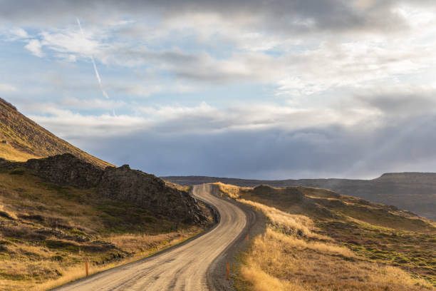 Roadtrip in Iceland dirt road in west iceland winding along atlantic coast during beautiful sunshine stock photo