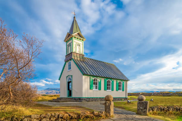 Thingvellir National Park in Iceland wooden church in front of sunny landscape stock photo