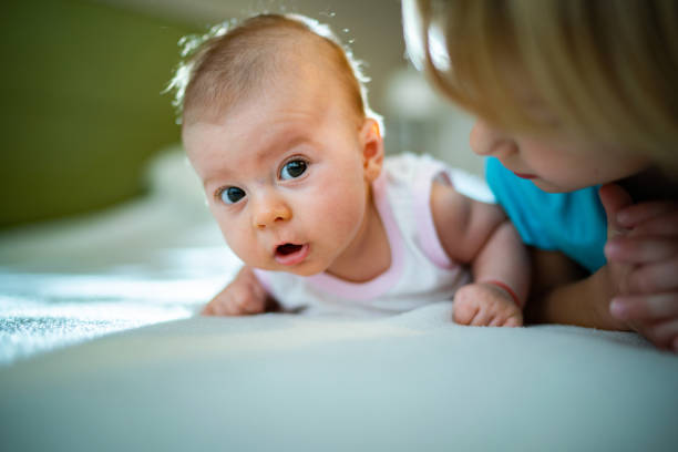 istock Baby girl lying with her brother 1209648909