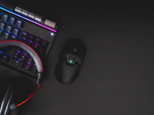 istock gamer work space concept, top view a gaming gear, mouse, keyboard, joystick, headset, mobile joystick, in ear headphone and mouse pad on black table background. 1209650313