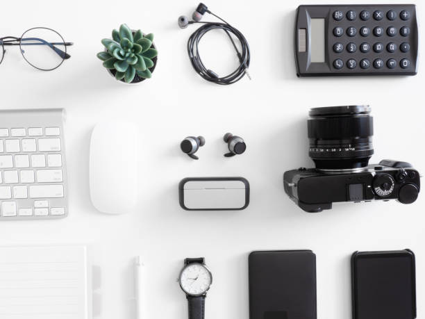 istock top view of office desk table with keyboard, smartphone, camera and notebook on white background, graphic designer, Creative Designer concept. 1209650326