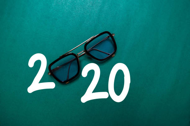 istock Happy New Year 2020 with Glasses isolated on the color table 1209652432