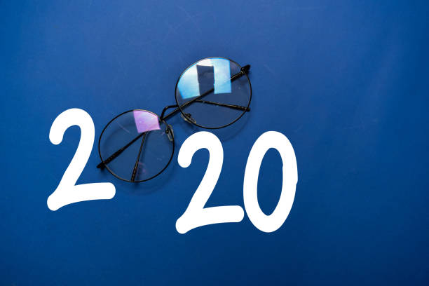 istock Happy New Year 2020 with Glasses isolated on the color table 1209652438