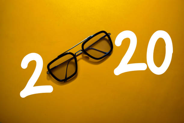 istock Happy New Year 2020 with Glasses isolated on the color table 1209652468