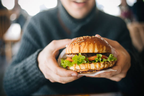 Man holding a hamburger