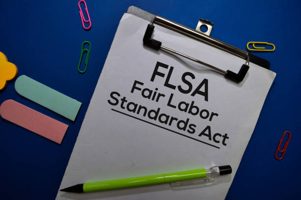 FSLA - Fair Labor Standards Act write on a paperwork isolated on Office Desk stock photo
