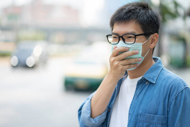 istock HandsomeMan wearing face mask protect filter against air pollution (PM2.5) or wear N95 mask. protect pollution, anti smog and viruses, Air pollution caused health problem. Global warming concept. 1209654506