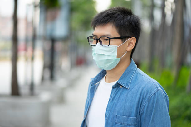 istock HandsomeMan wearing face mask protect filter against air pollution (PM2.5) or wear N95 mask. protect pollution, anti smog and viruses, Air pollution caused health problem. Global warming concept. 1209654513