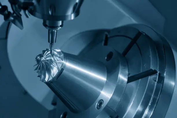 Photo of The 5-axis CNC milling machine  cutting the  aluminum  turbine propeller part by solid ball endmill tools.