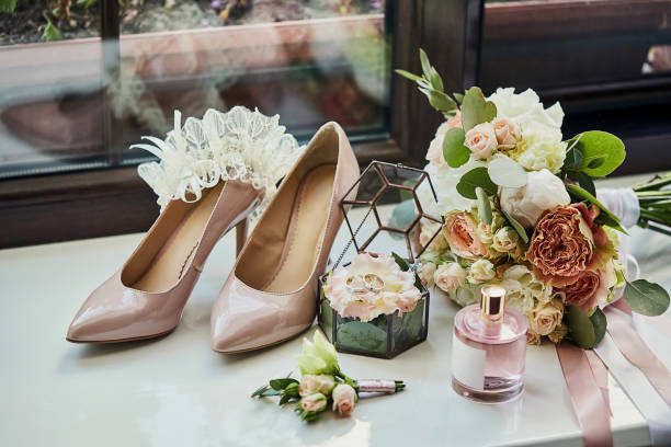 istock bridal accessories such as shoes, bouquet , ring and perfume lie on a table 1209655831