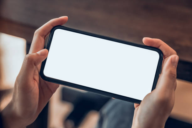 istock Hand holding blank screen of smartphone and for graphic display montage. 1209657930