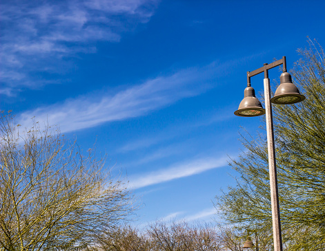 Two Lamp Light Post Against Blue Sky Background