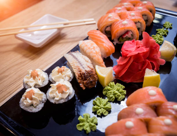 istock Sushi set. Rolls with salmon, eel and red caviar on a wooden plate. Restaurant. 1209662218