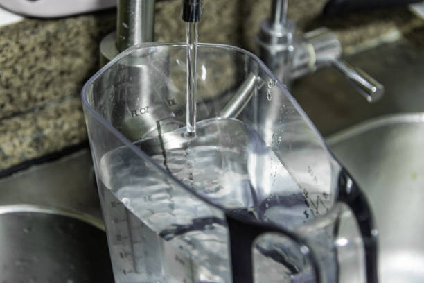 istock Filling the bottle with water 1209662274