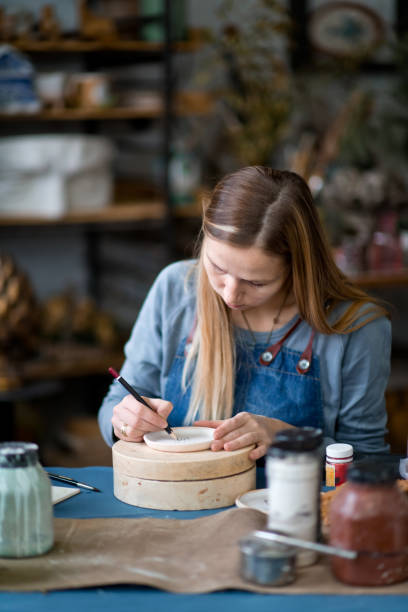 istock Young woman in her pottery workshop, small business concept 1209662483