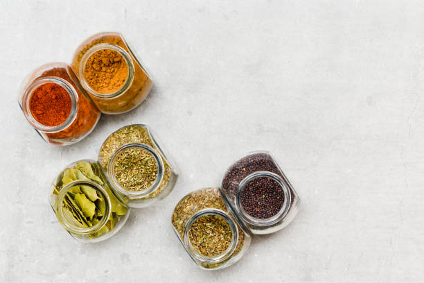 A selection of herbs and spices for adding flavour to food when cooking on a kitchen worktop at high angle A selection of herbs and spices for adding flavour to food when cooking on a kitchen worktop at high angle spice rack stock pictures, royalty-free photos & images