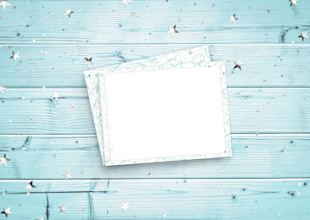 Composition of silver stars, sequins and openwork paper blank on a blue wooden table. Advertising content for Birthday, Valentine`s day, Women`s day, Christmas and New Year. Top view, copy space