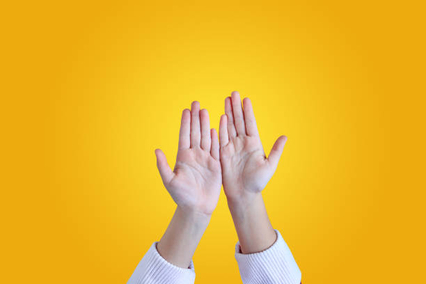 istock Close up kid hands gesture open palm isolated on yellow background. 1209666020