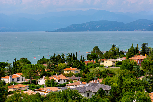 View of Lake Garda, summer landscape. Blue lake, mountayns Alps. Castelnuovo del Garda, Italy - August, 13 2019: Gardaland Theme Amusement Park in Castelnuovo Del Garda, Verona, Italy.