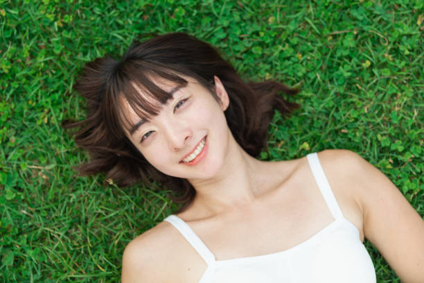 istock a woman lying on the lawn 1209668931