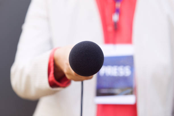 istock Female journalist holding microphone during media interview. Journalism concept. 1209669252