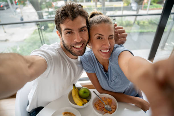 istock Couple taking a selfie while having breakfast at home 1209669579
