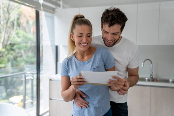 istock Happy couple at home checking the mail 1209669597