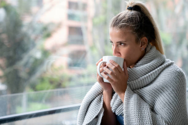 istock Woman at home drinking a cup of coffee 1209669659