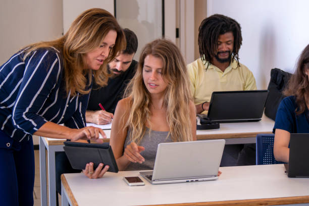 istock Group of students and a teacher in a classroom. 1209670851