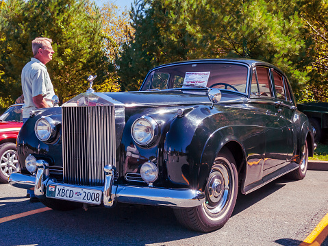 Bedford, Nova Scotia, Canada - September 16, 2012 : 1957 Rolls Royce Silver Cloud I at Annual Memory Lane Show & Shine, Bedford Place Mall. A man stands near and looks at the classic luxury car.