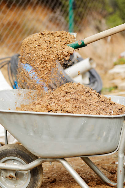 istock Gardener working with shovel and wheelbarrow filled with fresh soil 1209671979