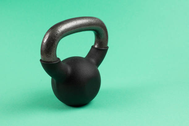 istock Black weight on green background. 4 kg weight. 1209672112