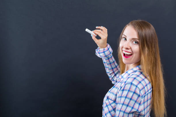 istock Woman holding a chalk 1209672690