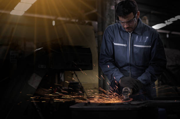 istock technicians are grinding iron at the shop causing sparks. 1209673607
