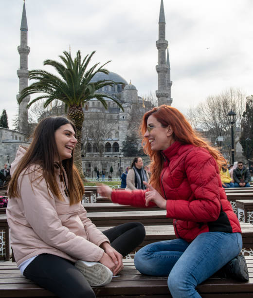 istock Two women sitting in front of Sultanahmet Mosque 1209675716