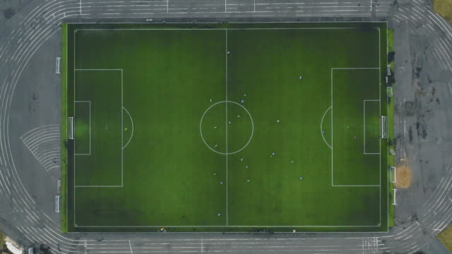 Aerial view of a football team playing in cold weather. Football field in top view