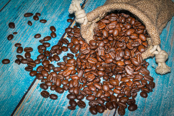 istock roasted coffee bean spilling out of coffee sack 1209676009