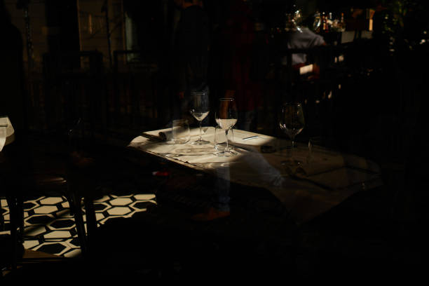 istock Wineglasses served in restaurant in light and shadow 1209676594