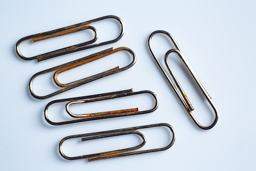 Rusty Paper clips on white acrylic background, Close up & Macro shot, Business, Education, Stationery concept