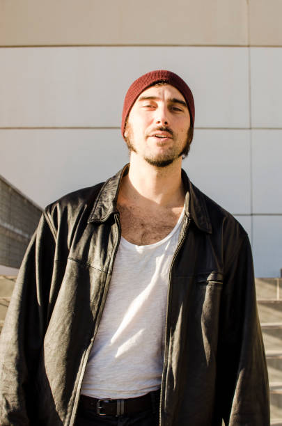 istock man with leather jacket and hat in casual attitude 1209677808