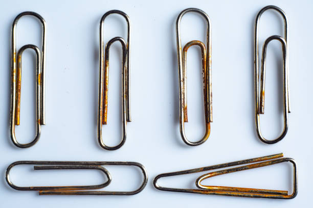 Rusty Paper clips on white acrylic background, Close up & Macro shot, Business, Education, Stationery concept
