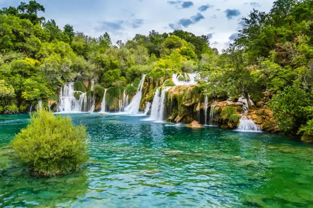 Photo of Krka Waterfalls in Krka National Park, Croatia. Skradinski buk is the longest waterfall on the Krka River with clear water and dense forest. Long exposure