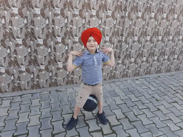 Photo of Little Sikh Boy Practices Basketball and Soccer (Football).